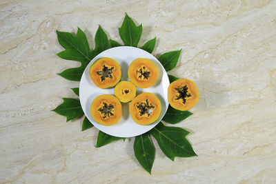 High angle view of fruits and leaves on table