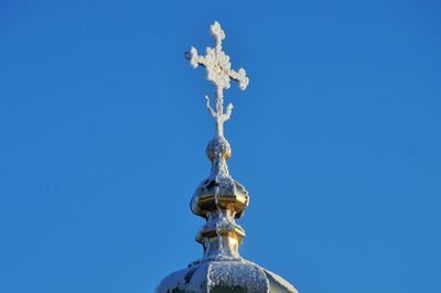 Low angle view of statue against blue sky