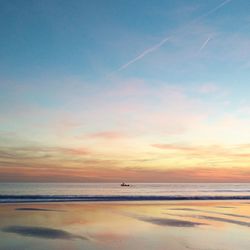 Scenic view of beach against sky during sunset