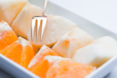 Close-up of orange and muskmelon pieces in plate