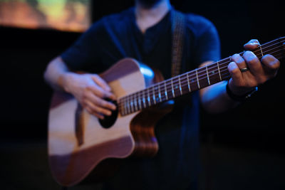 Guitarist, bassist plays a musical instrument on stage.  rock band performance.