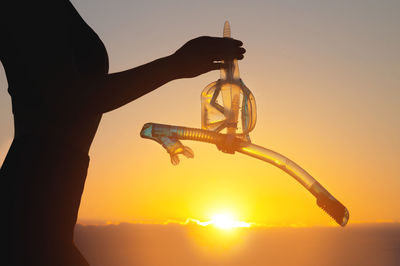 Low angle view of silhouette man standing against sky during sunset