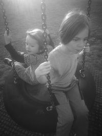 Girl playing with swing at playground