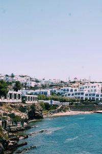 Town by sea against sky in city