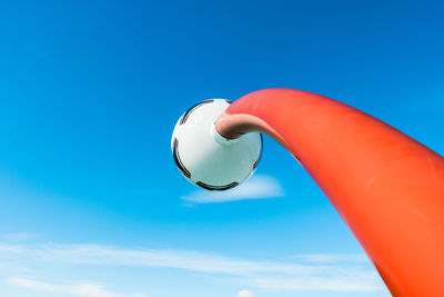 Low angle view of street light against blue sky