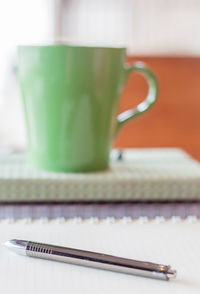 Close-up of pen and book on table