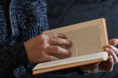 Midsection of woman reading book
