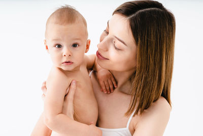 Portrait of cute baby girl against white background