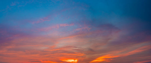 Low angle view of dramatic sky during sunset