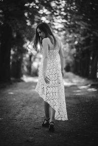 Rear view of woman walking on footpath