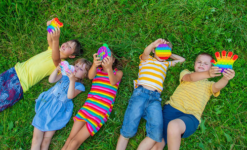 High angle view of boy playing with toys on field