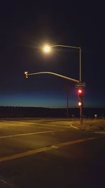 Airplane on road against sky at night