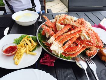 High angle view of french fries and crab legs on plate