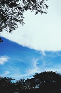 Low angle view of bubbles against sky