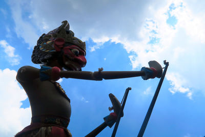Low angle view of puppet against sky