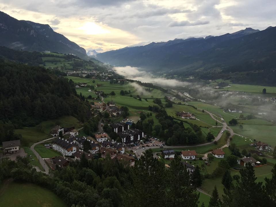 mountain, mountain range, high angle view, village, valley, rural scene, landscape, nature, field, grass, cloud - sky, tree, building exterior, agriculture, sky, outdoors, beauty in nature, no people, terraced field, architecture, day, participant