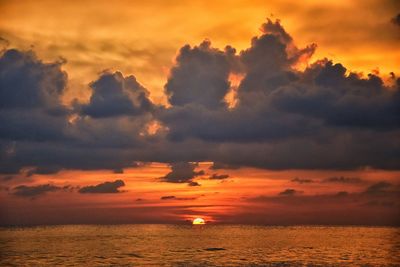 Phuket beach sunset, colorful cloudy twilight sky reflecting on the sand indian ocean thailand asia