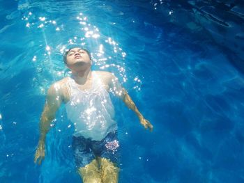 High angle view of woman swimming in pool