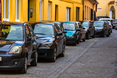 View of cars parked on street in city