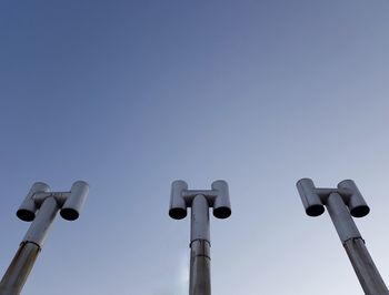 Low angle view of electric lamp against clear blue sky