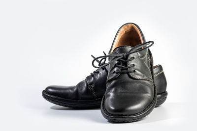 Close-up of shoes against white background