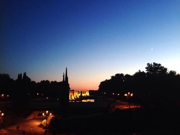 Illuminated built structure against clear sky at night