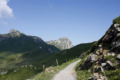 Road amidst mountains against clear sky