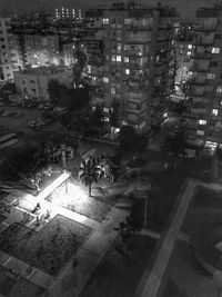 High angle view of city street and buildings at night