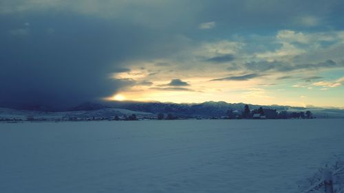 Scenic view of snow covered landscape at sunset