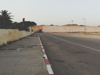 Empty road against clear sky