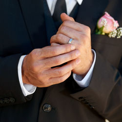 Midsection of bride holding bouquet