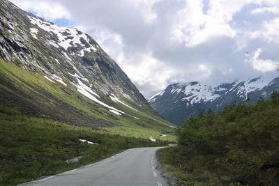 Road amidst mountains against sky