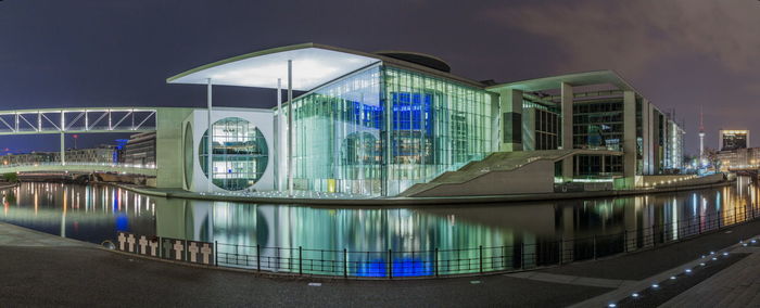 Illuminated modern building against sky at night