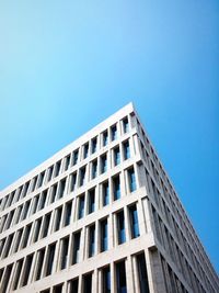 Low angle view of building against clear blue sky