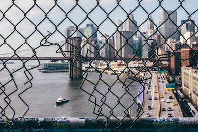 Bridge over river seen through chainlink fence