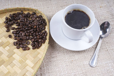 High angle view of coffee beans in cup on table