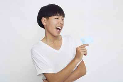 Portrait of a smiling young man against white background