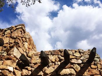 Low angle view of rocks against sky