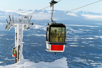 Overhead cable car against snowcapped mountains