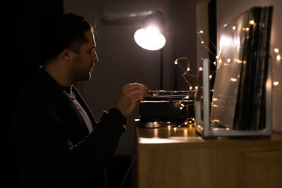 Side view of a man working in the dark