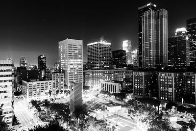 High angle view of city lit up at night