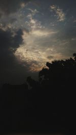 Silhouette trees on landscape against sky at sunset