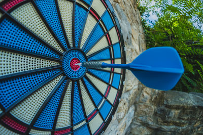 Low angle view of dart in dartboard outdoors