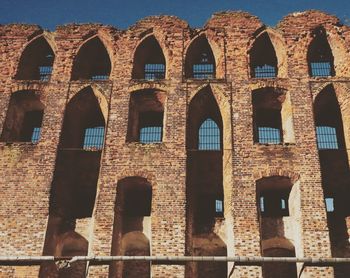 Low angle view of old arched wall