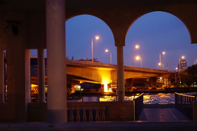 Illuminated bridge at night