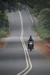 Man riding motorcycle on road