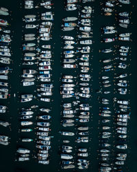 Aerial view of boats moored on sea at harbor