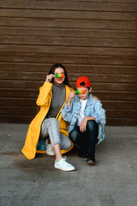 High angle view of boy sitting on hardwood floor