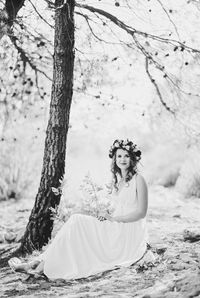 Portrait of woman standing in forest