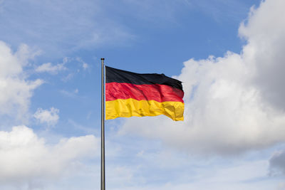 Low angle view of flag against sky